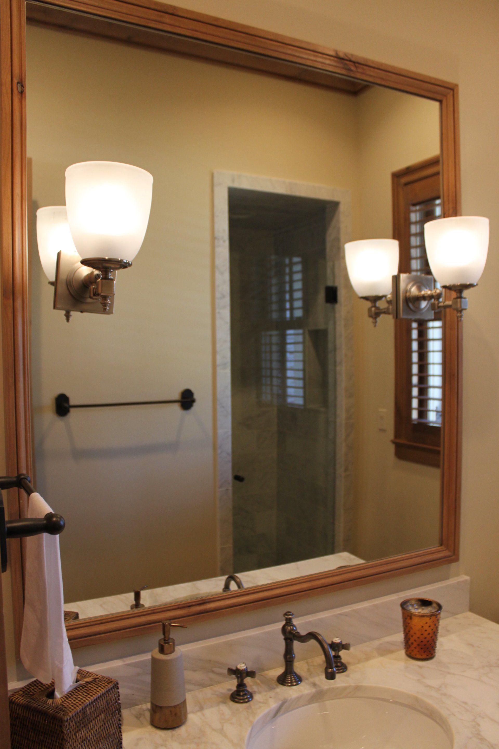 A bathroom with a large mirror and a sink.