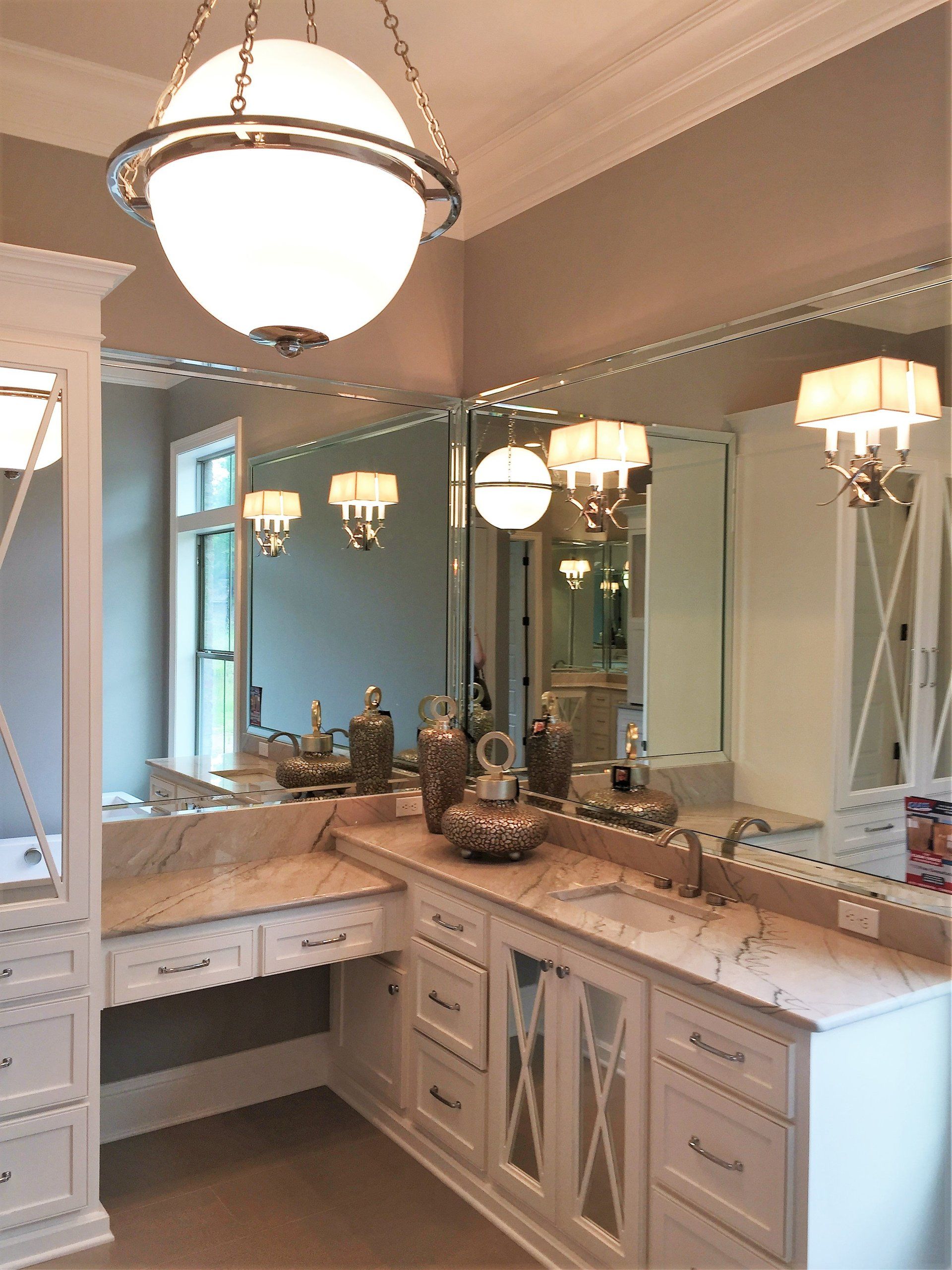 A bathroom with two sinks and a large mirror.