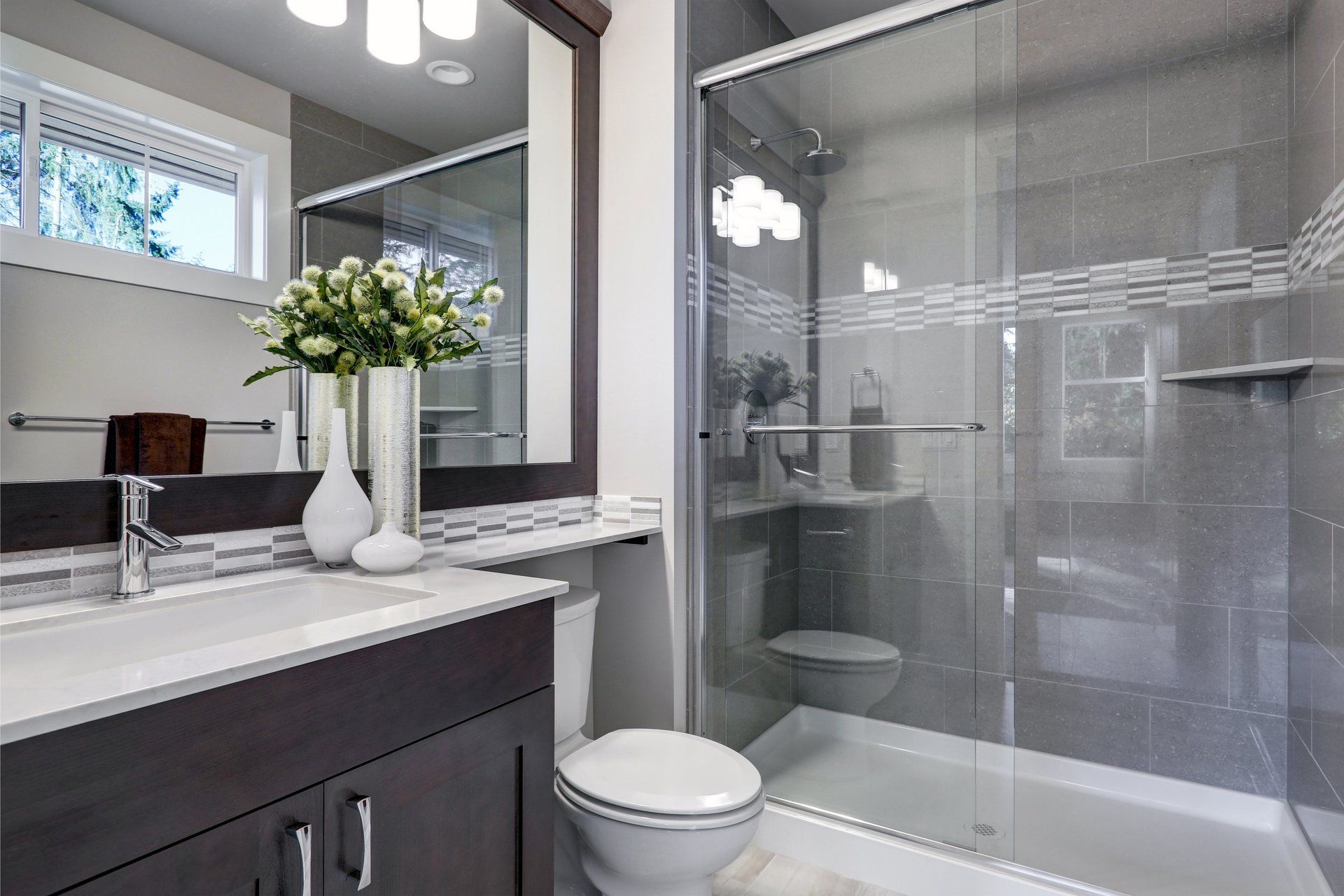A bathroom with a toilet , sink , and shower.