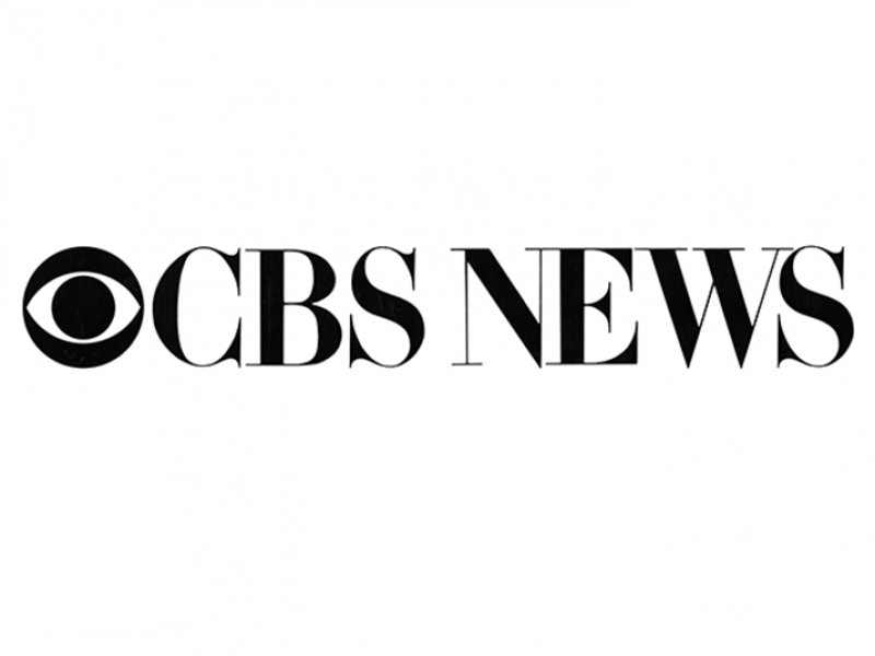 CBS News logo: Black text on white background. “CBS” with a circle eye icon followed by