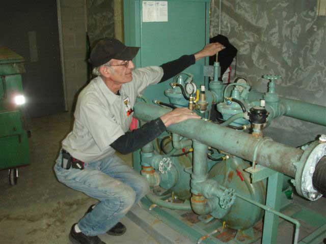 Veteran Plumber Checking Pipes — Kalamazoo, MI — Zimmerman Plumbing & Heating Service