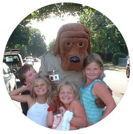 Four Children standing with a Watch Dog Mascot