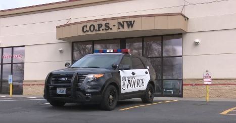 Police cruiser parked in front of the C.O.P.S NW Building