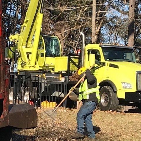 Man Holding Rake — Dedham, MA — Royer Tree Service Inc Man Holding Rake — Dedham, MA — Royer Tree Service Inc