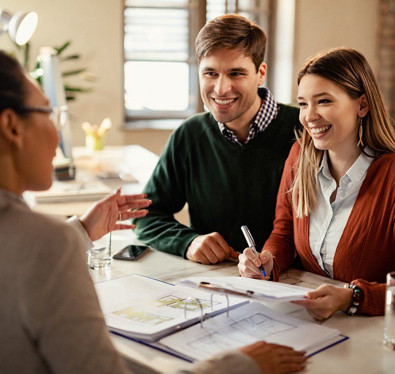 Happy Couple Signing Mortgage Contract — Plymouth, MA — Derby Street Mortgage Inc.