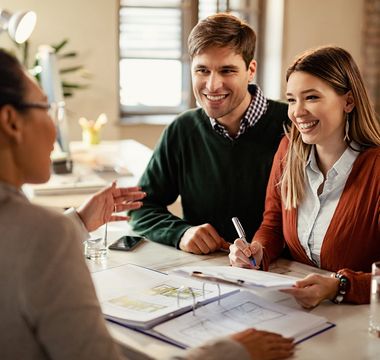 Happy Couple Signing Mortgage Contract — Plymouth, MA — Derby Street Mortgage Inc.