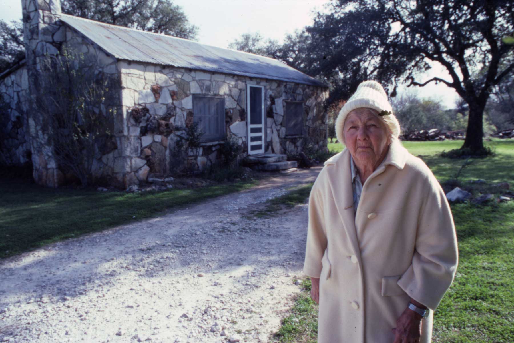 Edna Patterson in front of her house
