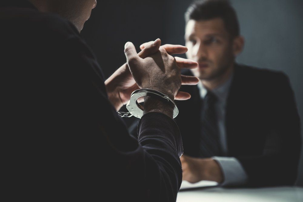Criminal Man with Handcuffs Being Interviewed — Griffin, GA — Law Offices of Beck, Owen & Murray
