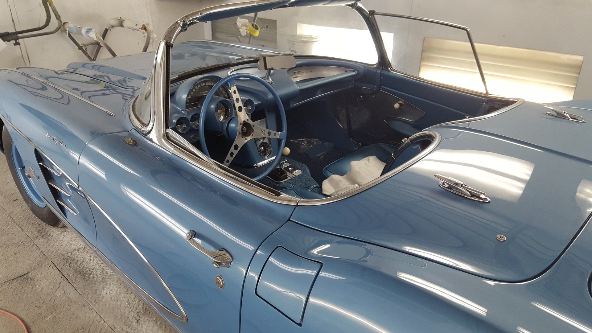 Light blue classic convertible car with blue interior.