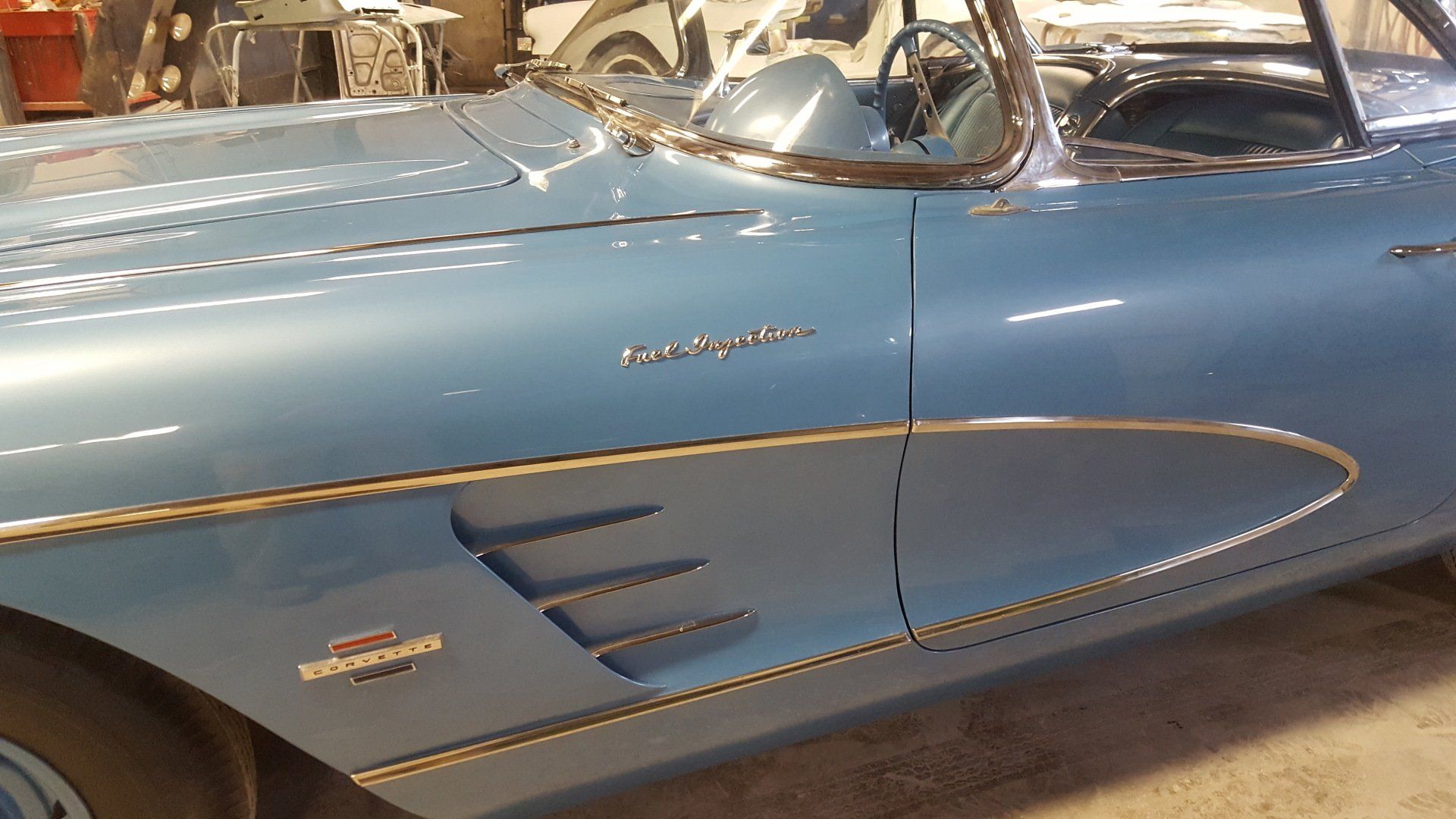 Light blue vintage Chevrolet Corvette convertible, side view. Chrome trim, 