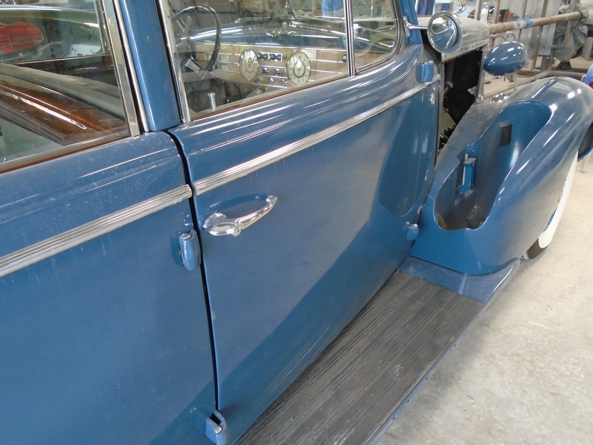 Blue vintage car door and running board.