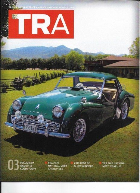 Green classic car on grassy lawn, magazine cover with 