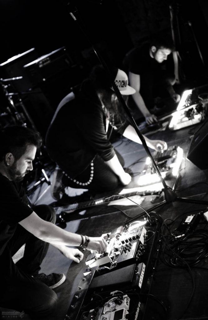a group of people are playing instruments on a stage in a dark room .