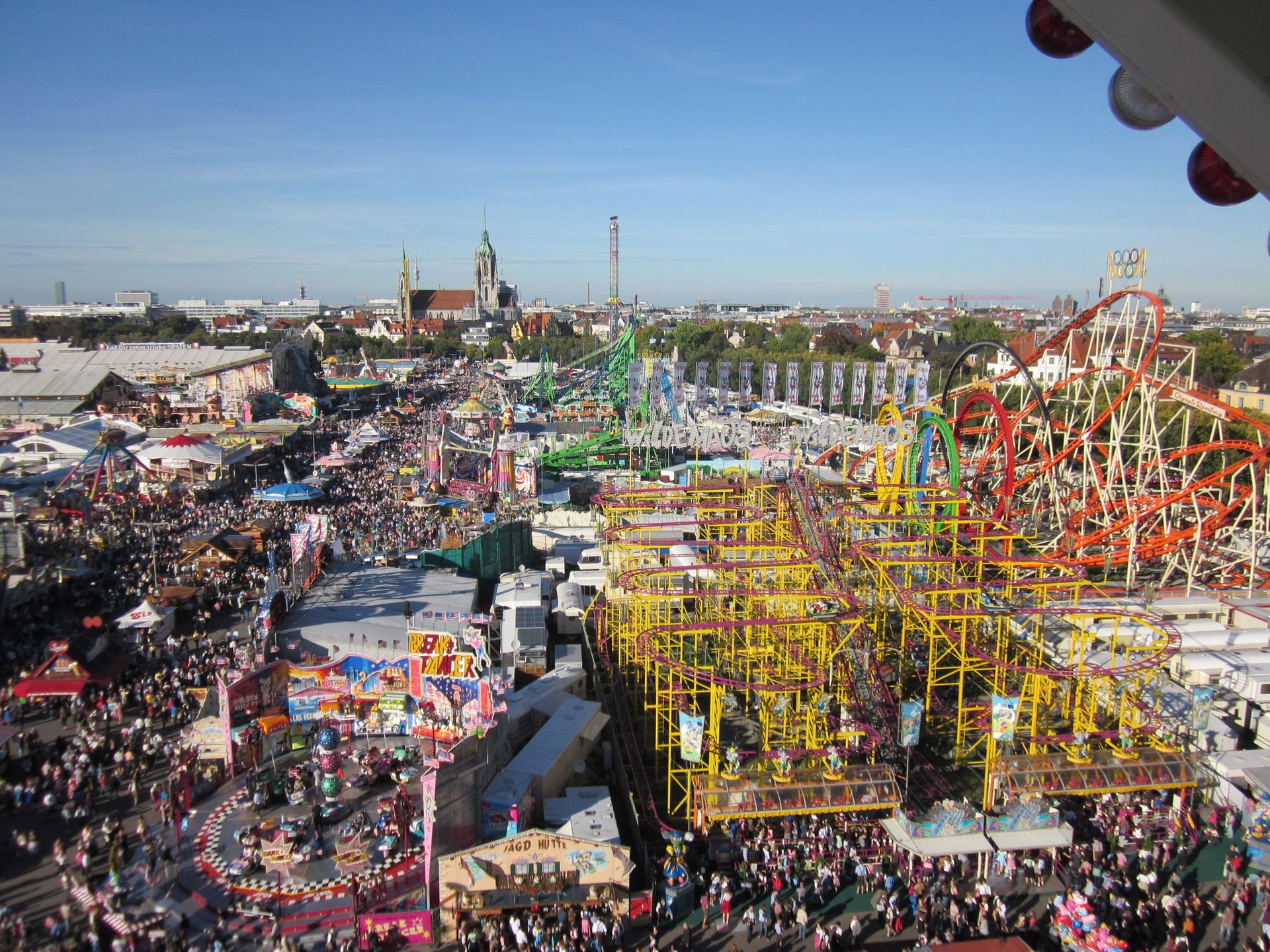 A large crowd of people are gathered at a carnival