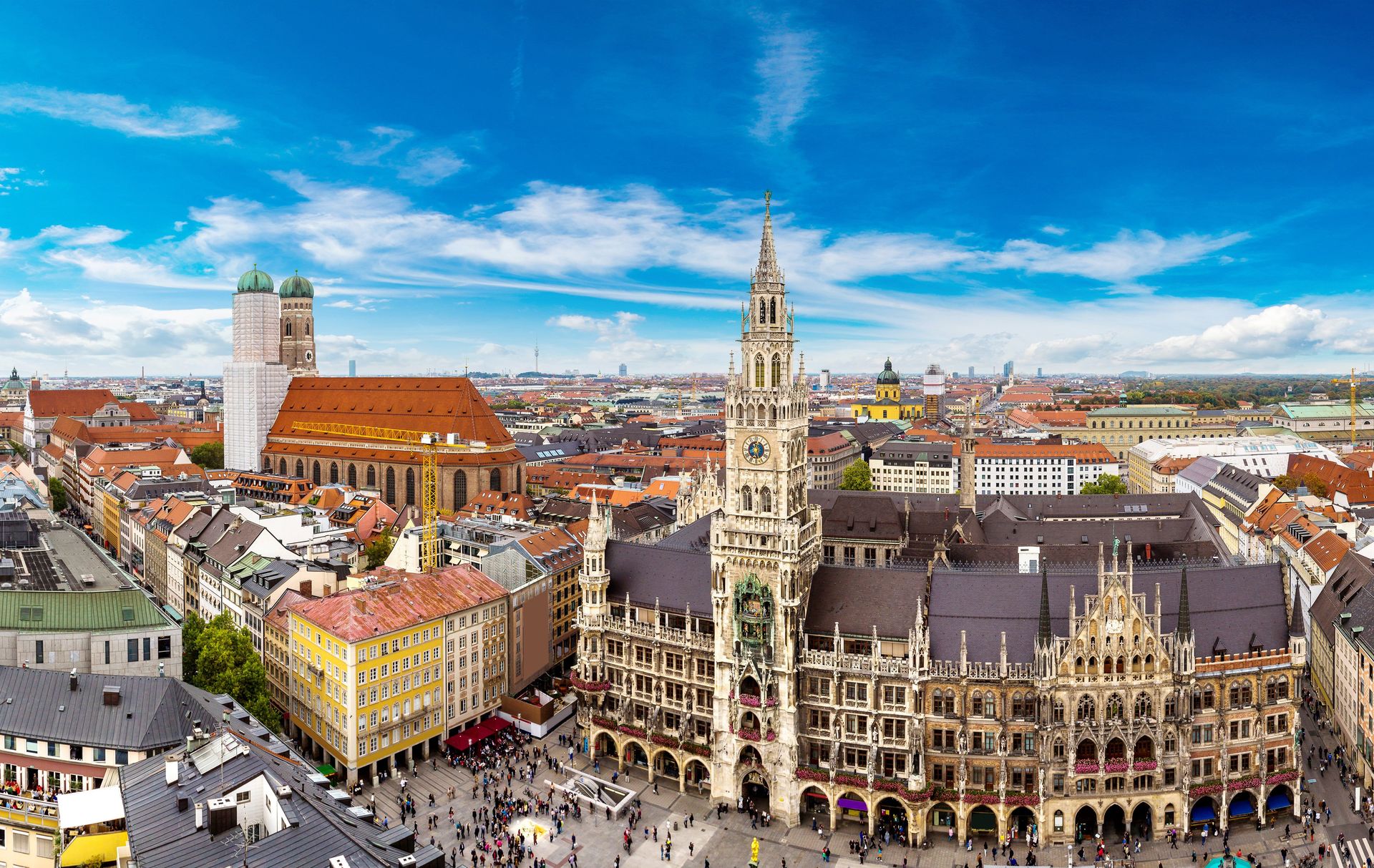 An aerial view of a city with a large building in the middle of it.