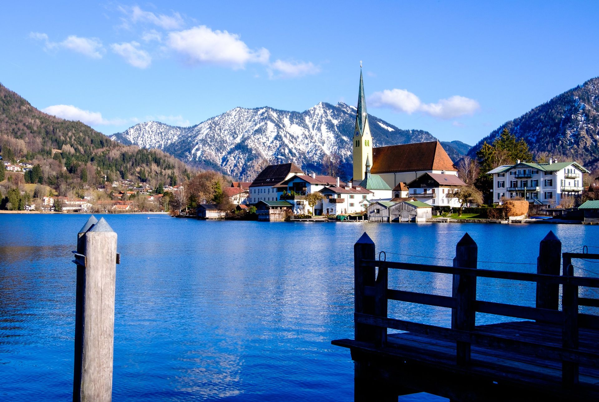 A lake with mountains in the background and a dock in the foreground