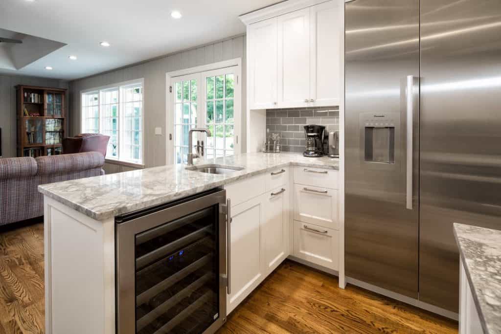 Kitchen counter details with wine cooler and stainless steel refrigerator