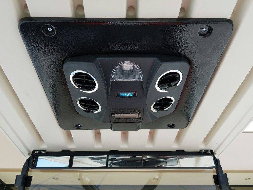 A ceiling mounted air conditioner with a light on it