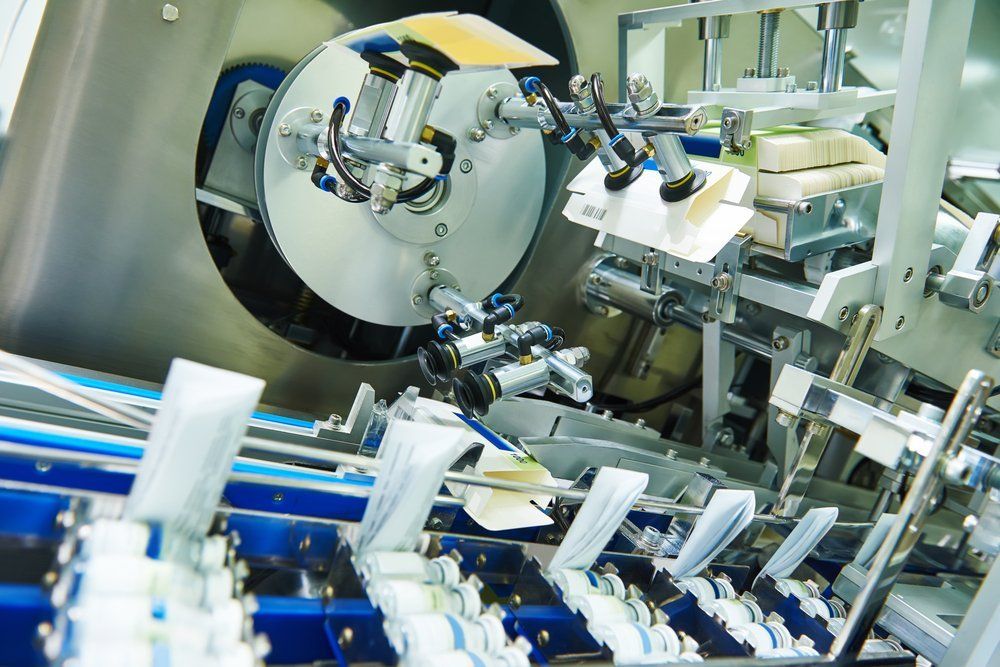 A machine is working on a conveyor belt in a factory