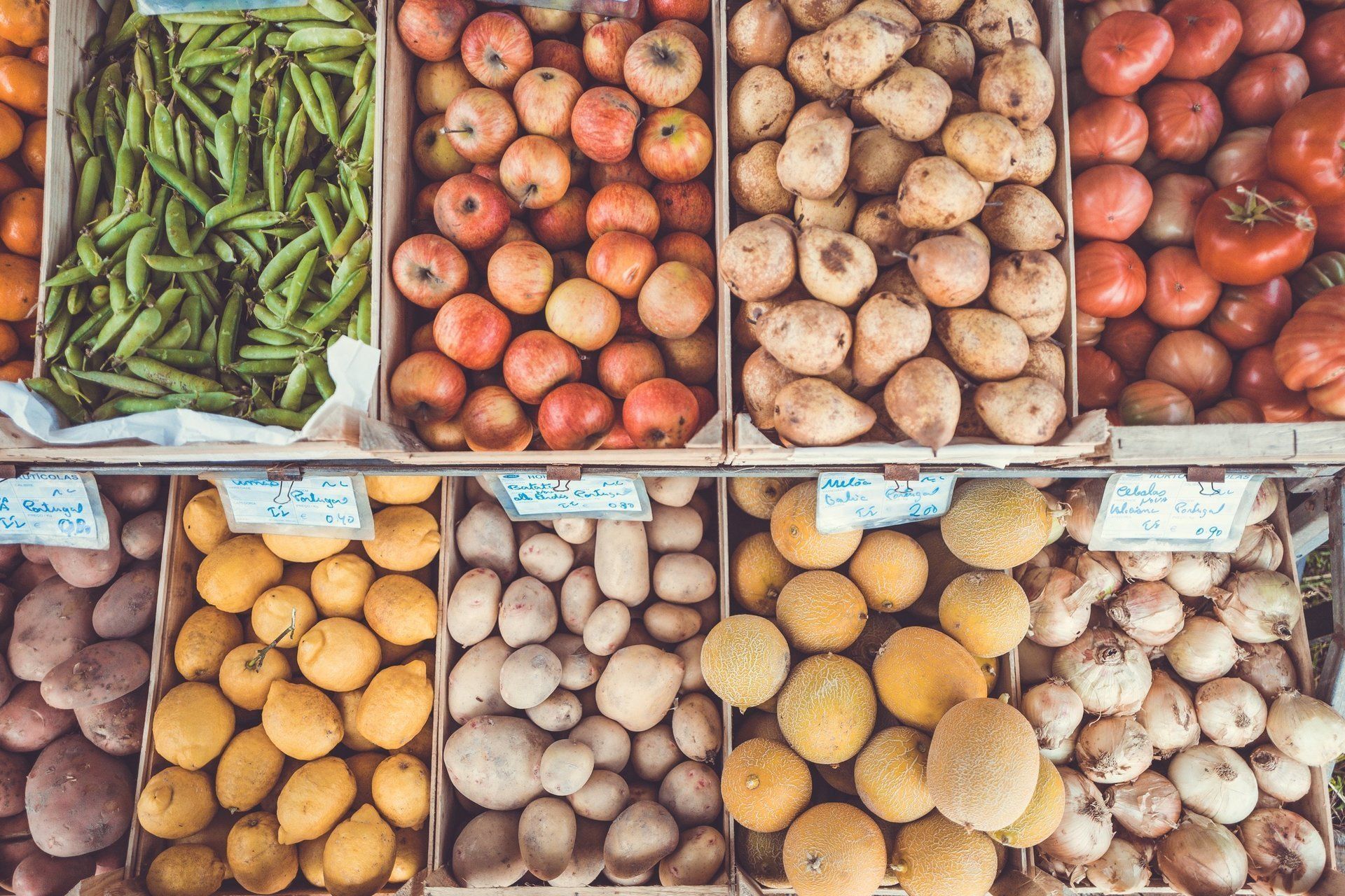 A variety of fruits and vegetables are on display at a market.