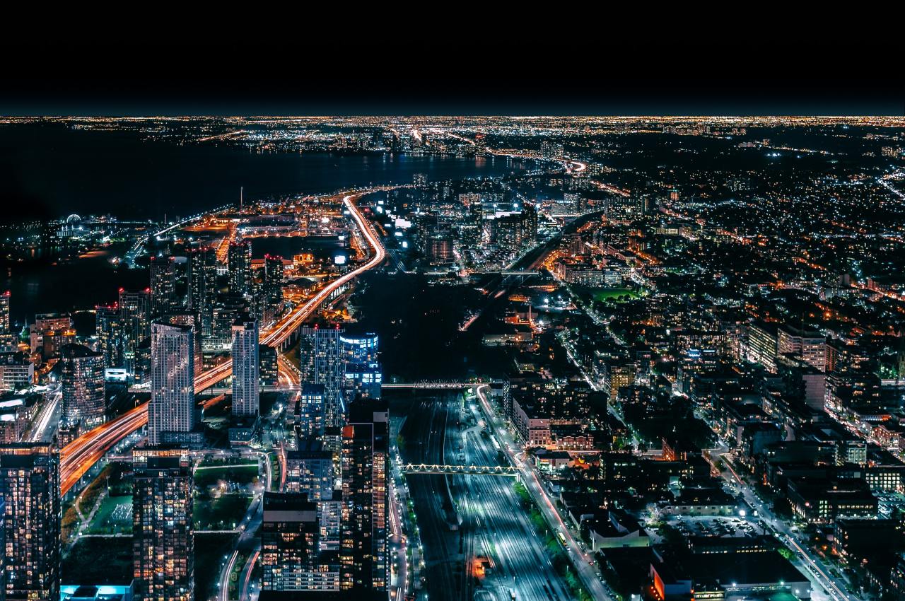An aerial view of a city at night with lots of lights.