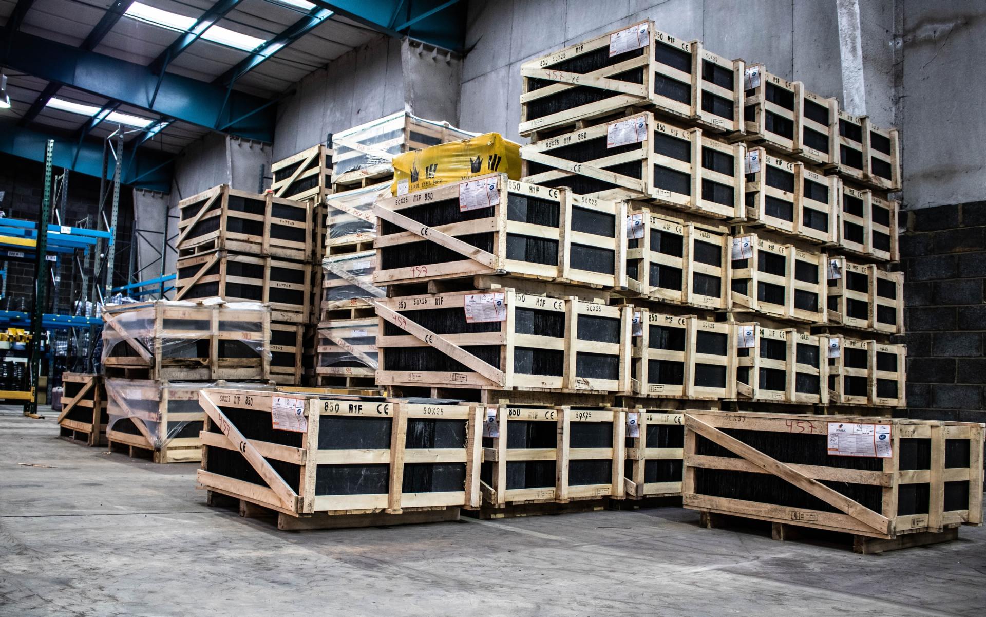 A warehouse filled with lots of wooden crates stacked on top of each other.