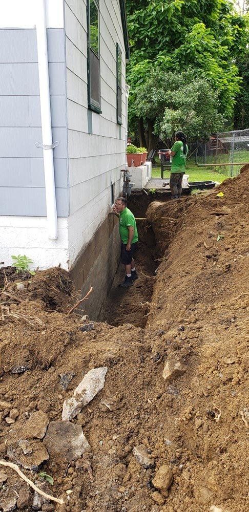 Men Doing the Foundation Sealing — Pine Bush, NY — Creative Touch Landscaping & Home Improvement Inc.