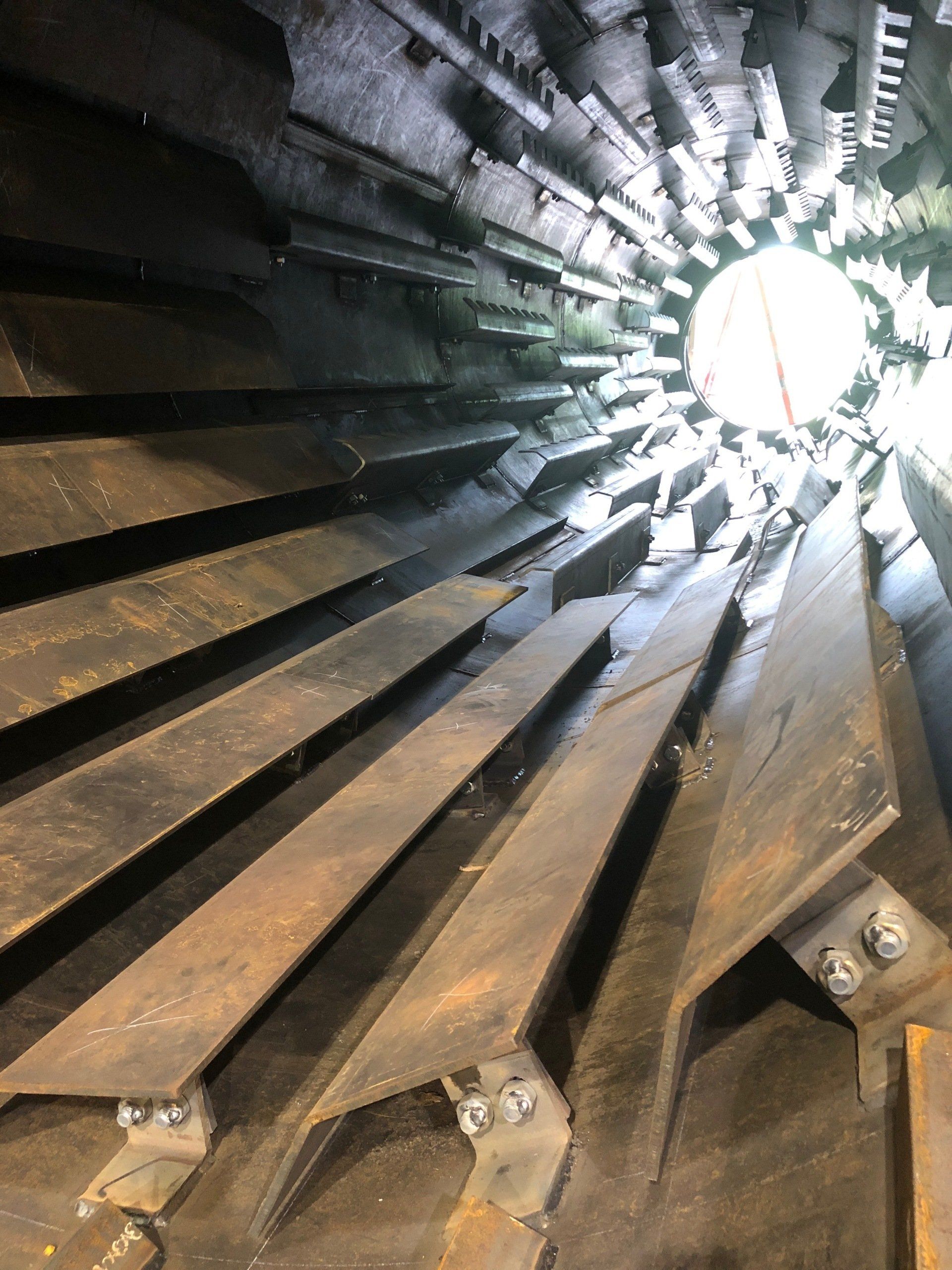 A close up of a metal structure with a light shining through it.
