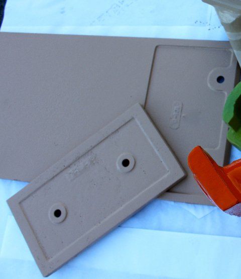 Two pieces of plastic with holes in them are laying on a table