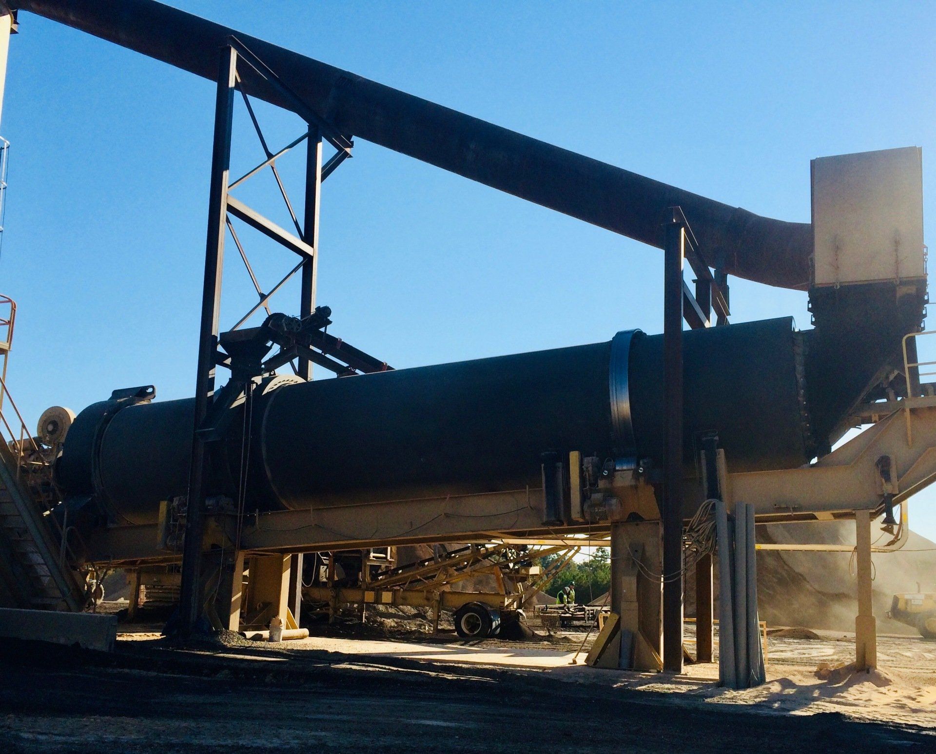 A large pipe in a factory with a blue sky in the background