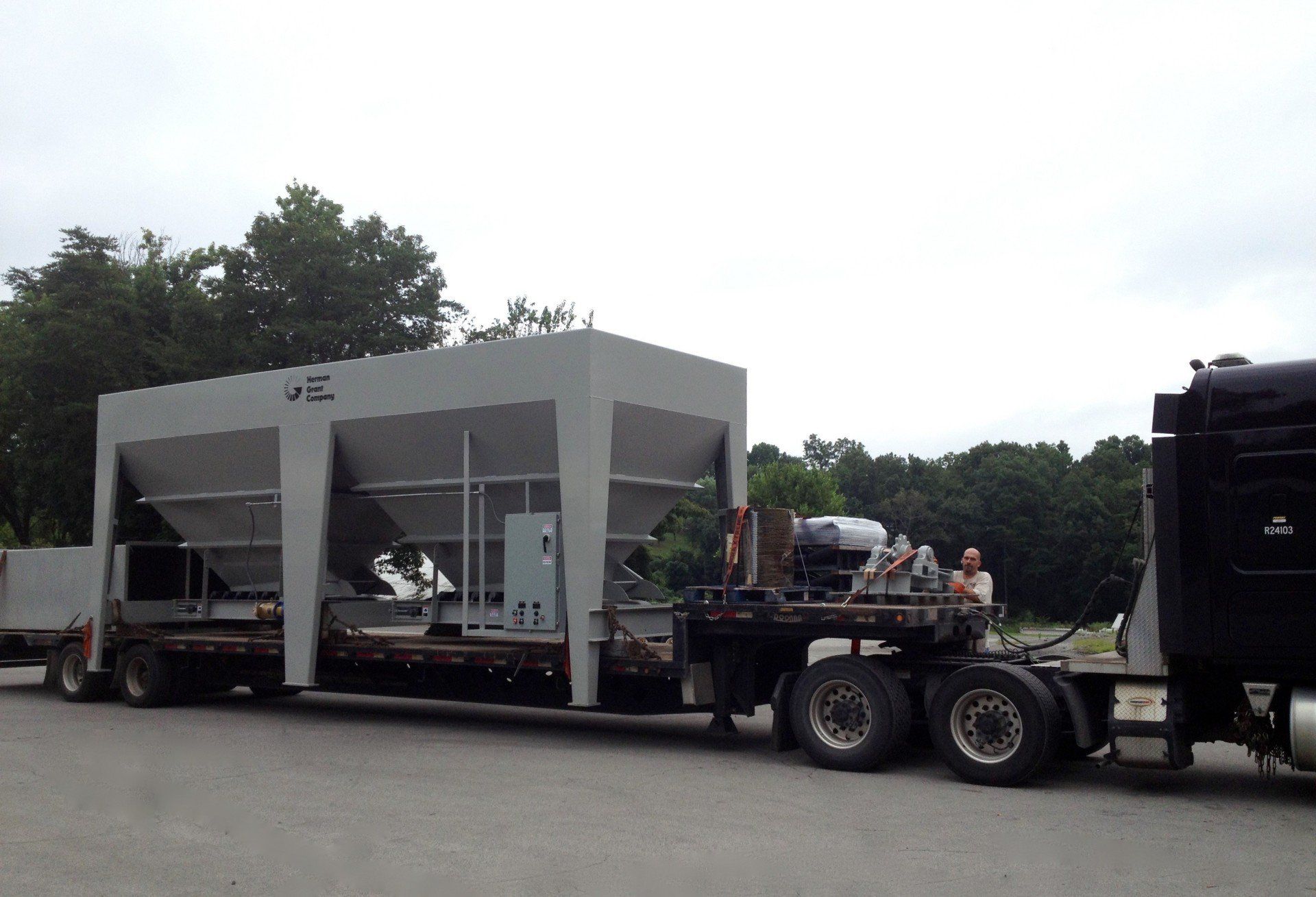 A semi truck is carrying a large concrete structure