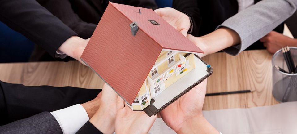 Realtors holding a model house