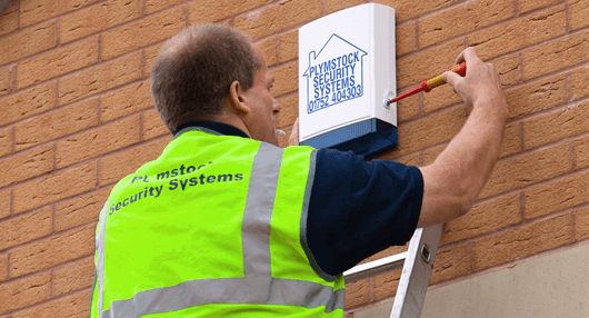 man installing a security system