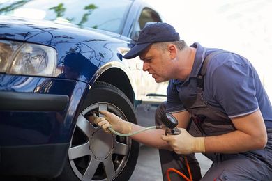 Mechanic checking tyre pressure — Advance Tyres Gympie