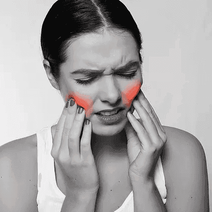 Person pressing both sides of their jaw, showing visible jaw discomfort.