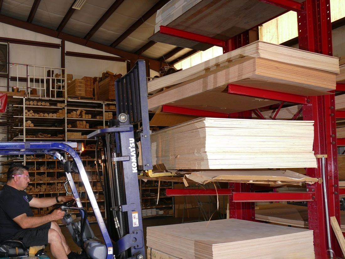 Worker Stacks Plywood