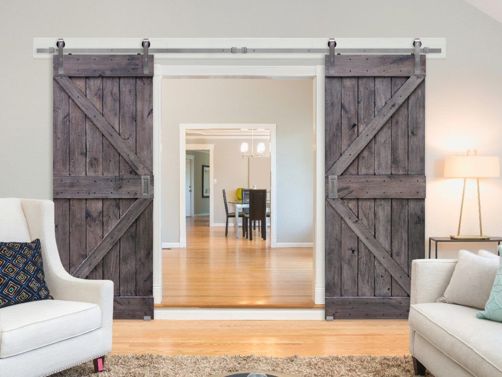Two grey sliding doors with barn door hardware in Conroe, TX