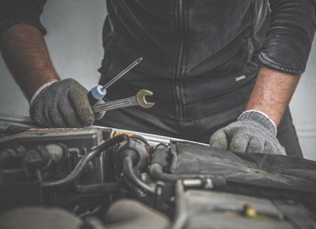 Auto Repair — A Mechanic Holding Car Repair Tools in Antioch, CA Auto Repair — A Mechanic Holding Car Repair Tools in Antioch, CA