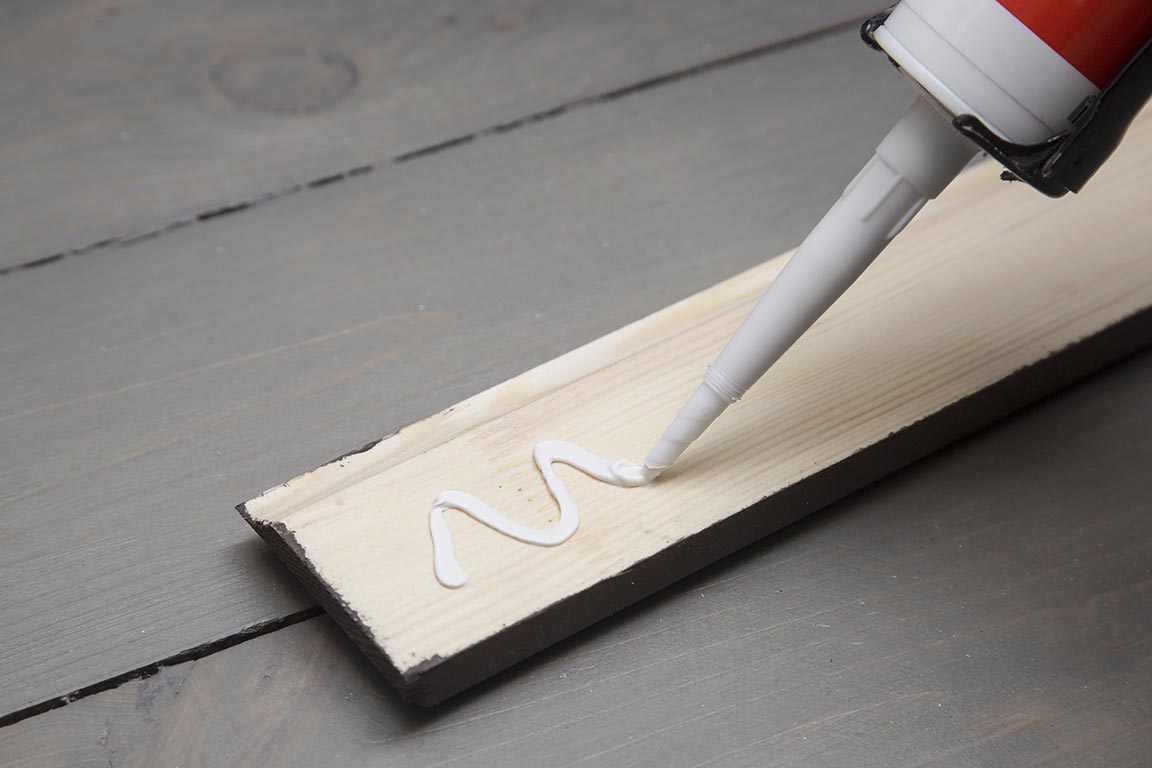 Putting Glue on a Piece of Wood — Floor Installation in Bundaberg, QLD