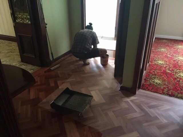 Builders Laying Wooden Floor — Floor Installation in Bundaberg, QLD