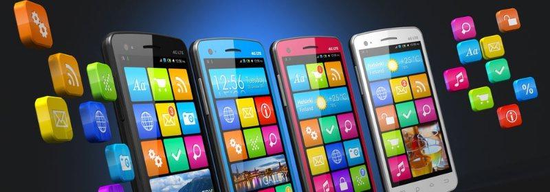 A group of cell phones sitting next to each other on a table.