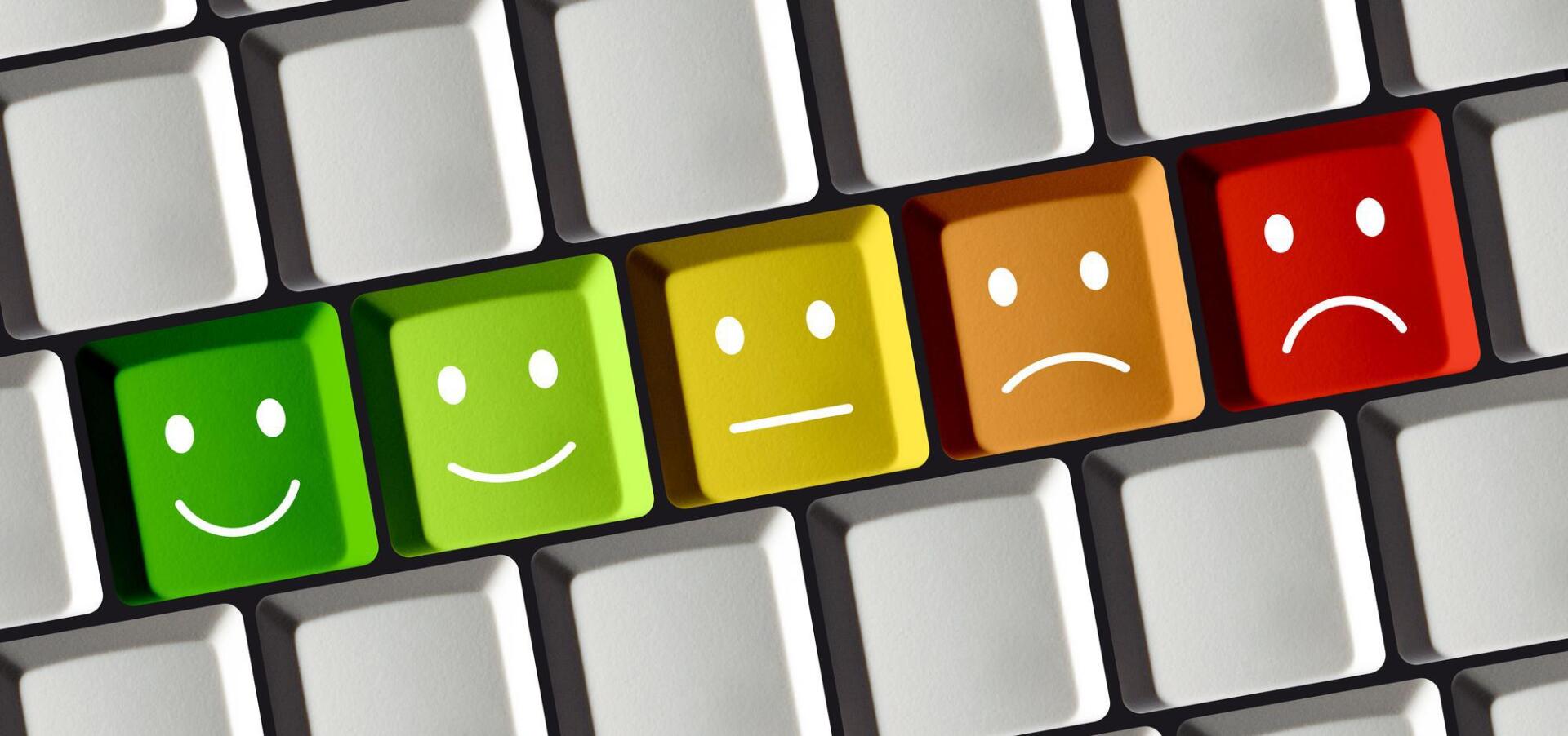 A keyboard with smiley faces and sad faces on them