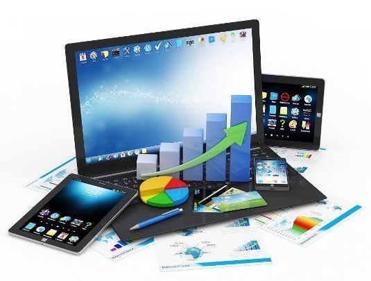A laptop , tablet , phone , and pen are sitting on top of a table.