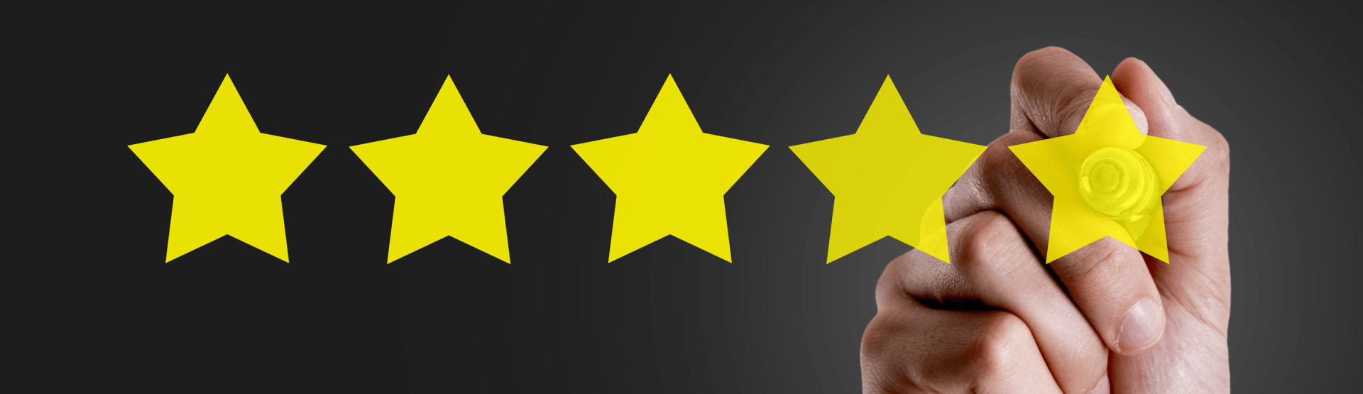 A hand is holding a yellow star in front of a row of yellow stars.