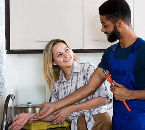 Plumber and Satisfied Customer Smiling — Backflow Prevention in Shelby Township, MI Plumber and Satisfied Customer Smiling — Backflow Prevention in Shelby Township, MI