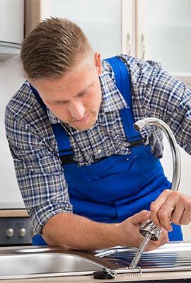 Plumber Fixing a Kitchen Sink — Drain Backups in Shelby Township MI Plumber Fixing a Kitchen Sink — Drain Backups in Shelby Township MI