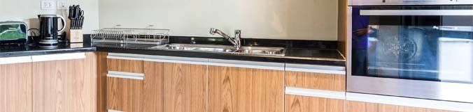 A kitchen with wooden cabinets and stainless steel appliances.