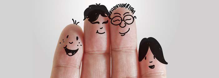 A group of fingers with faces drawn on them.