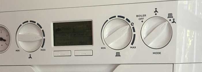 A close up of a white appliance with a clock on it.