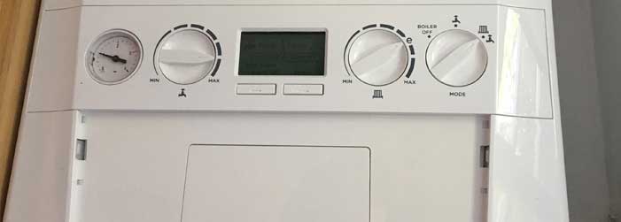 A close up of a white appliance with a clock on it.